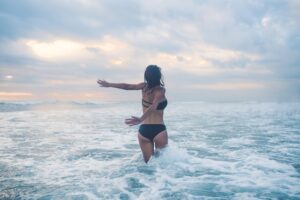 woman playing in the ocean