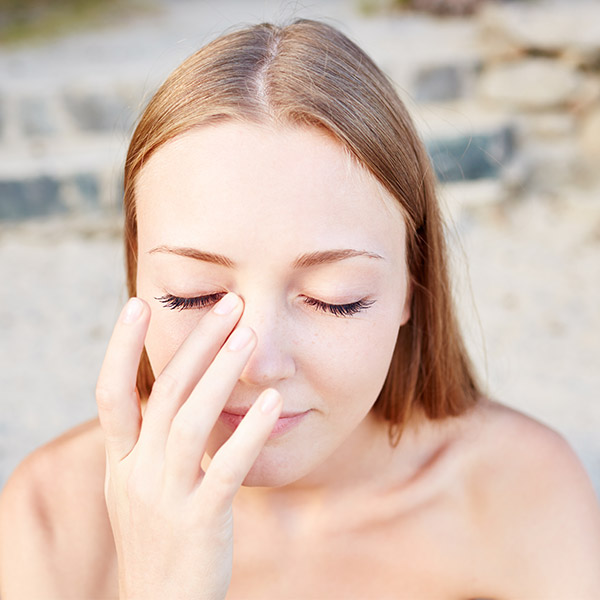 young woman touching her eye